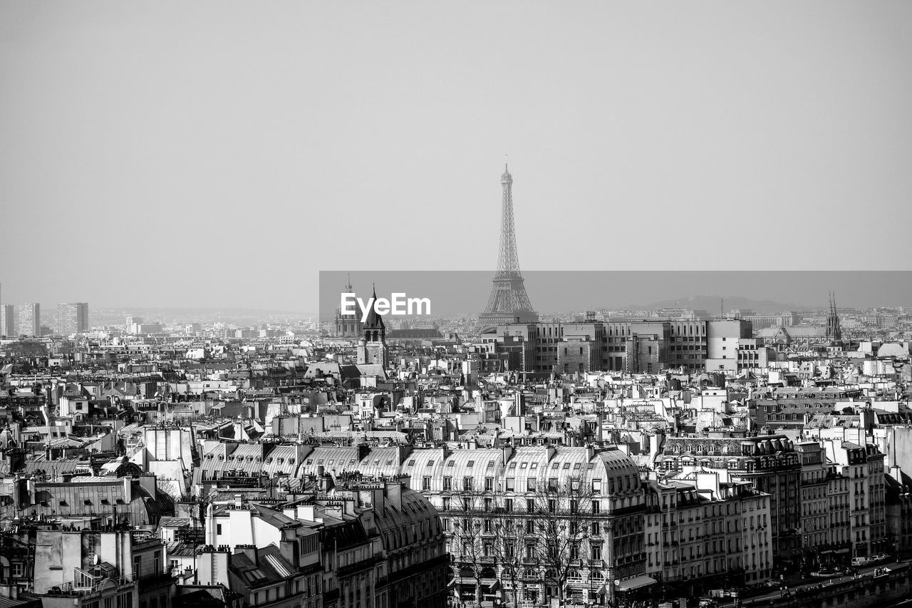 Distant view of eiffel tower against sky in city