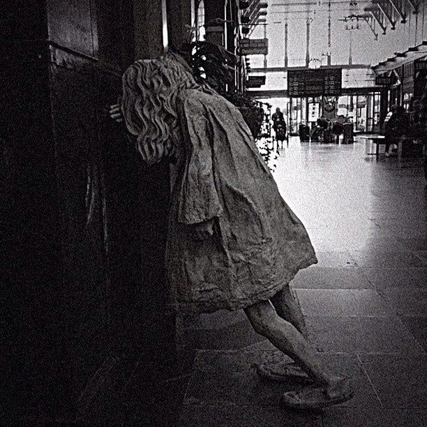 WOMAN STANDING IN CITY