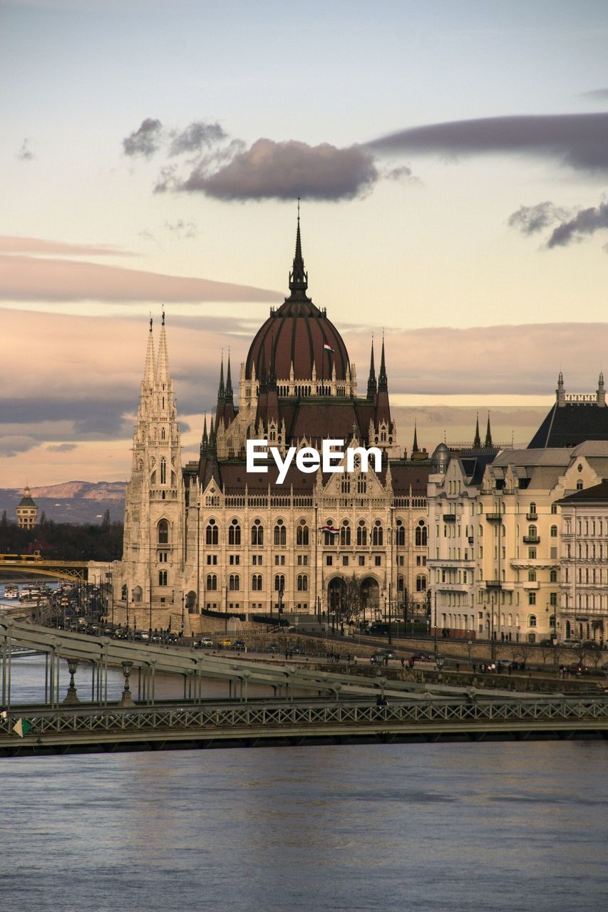 Hungarian parliament building and river against sky