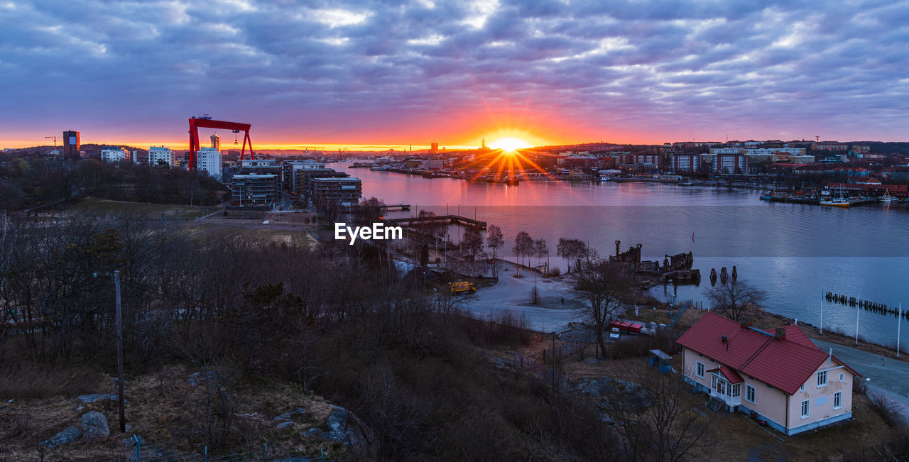 A stunning gothenburg sunrise over the river with cloud-filled skies creating a beautiful cityscape.