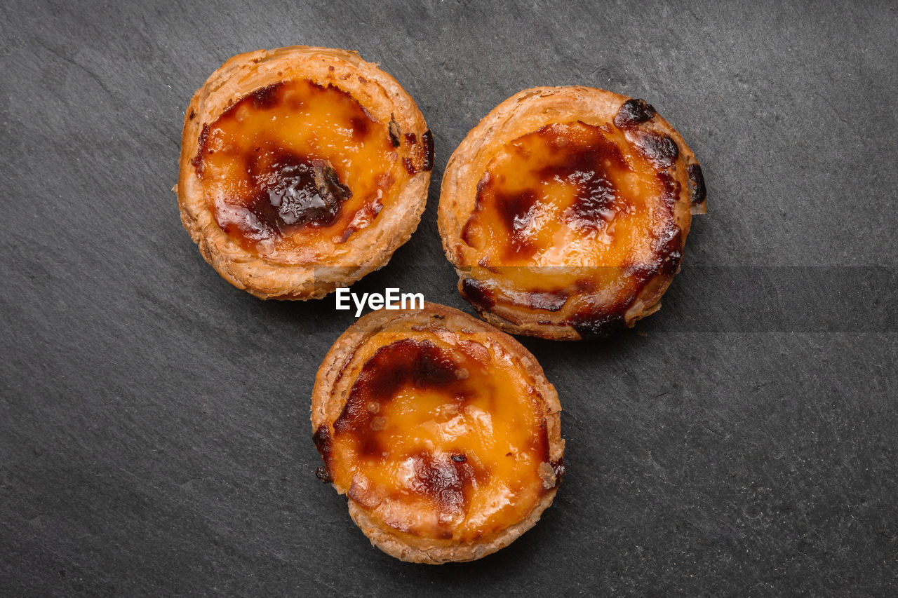 Close up of portuguese 'pasteis de nata', custard tart on a dark background