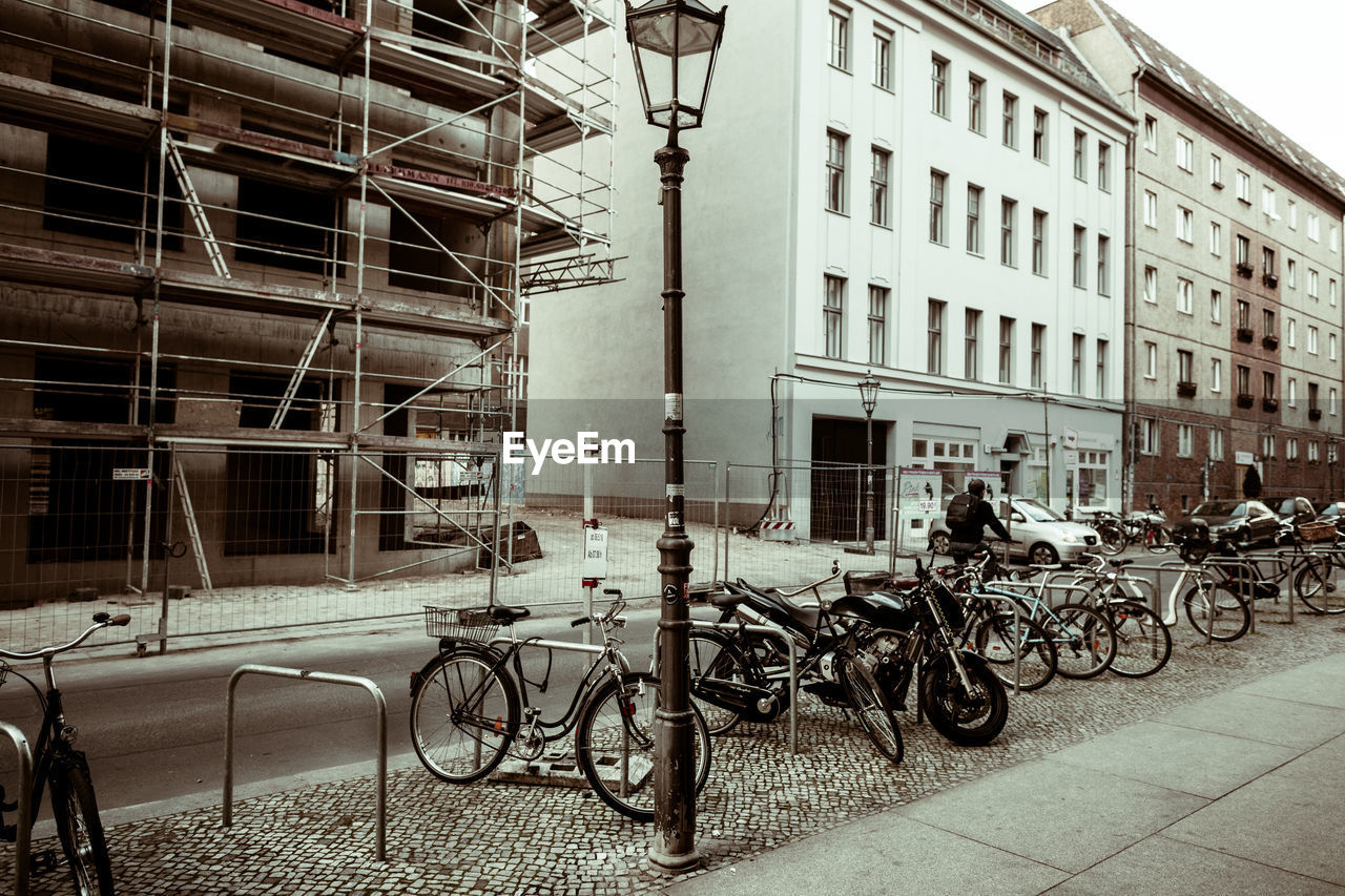 Bicycles parked on footpath in front of buildings