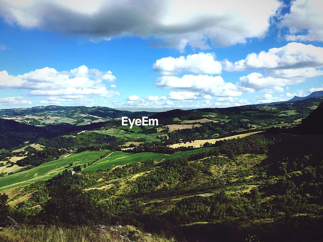 High angle view of green mountains against sky