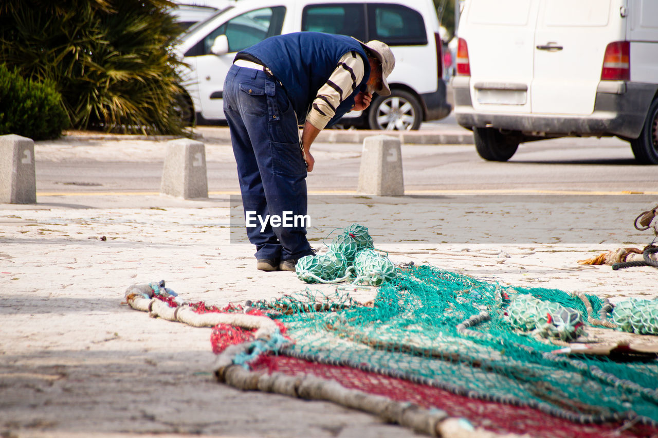 MAN WORKING IN STREET