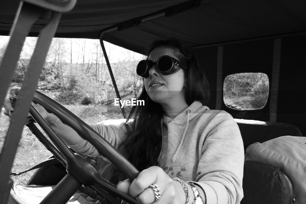 Young woman sitting in car