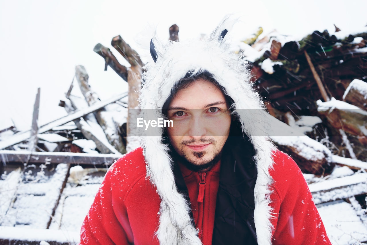 Portrait of man standing in snow