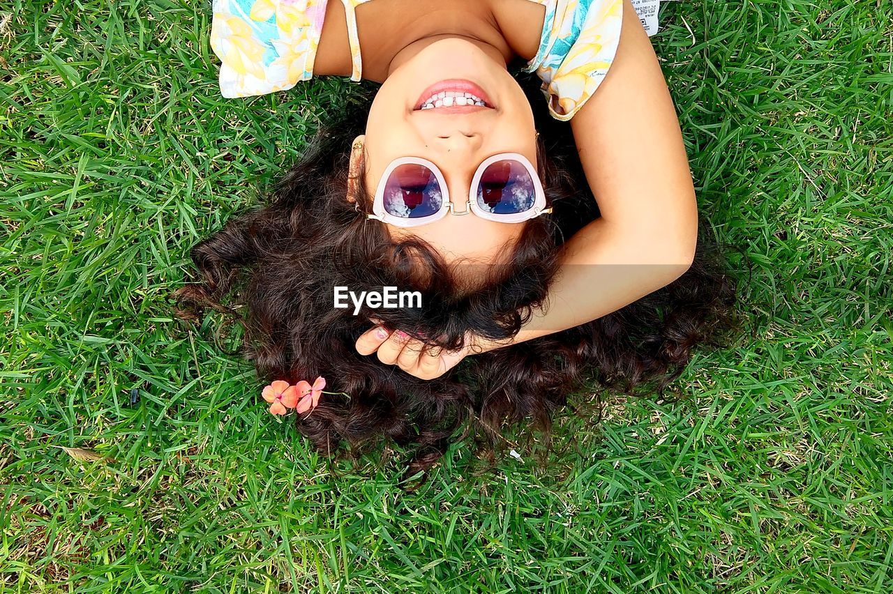 High angle view of woman lying down on grass