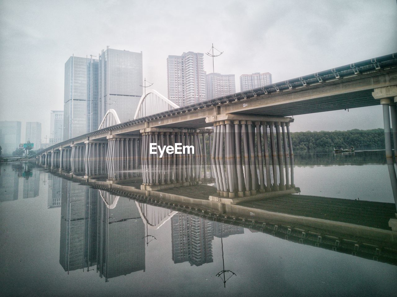 Bridge over river with buildings in background