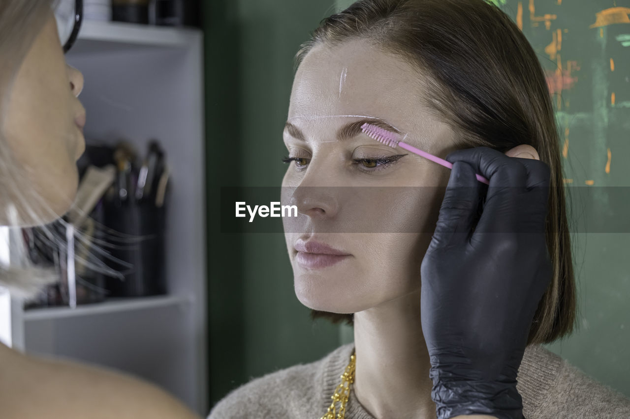 Eyebrow lamination procedure styling, correction, coloring and in beauty salon, eye brow care 
