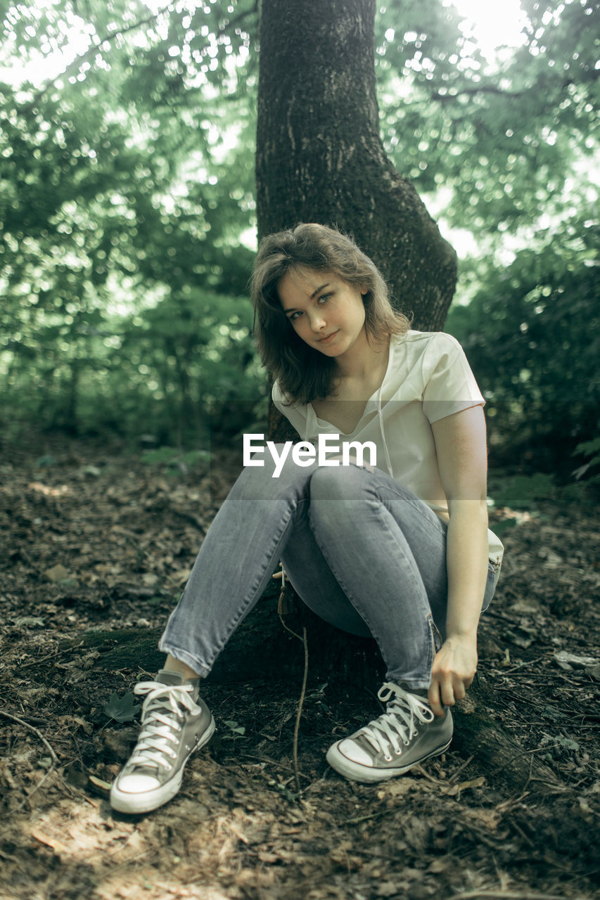 Low section of woman sitting on field