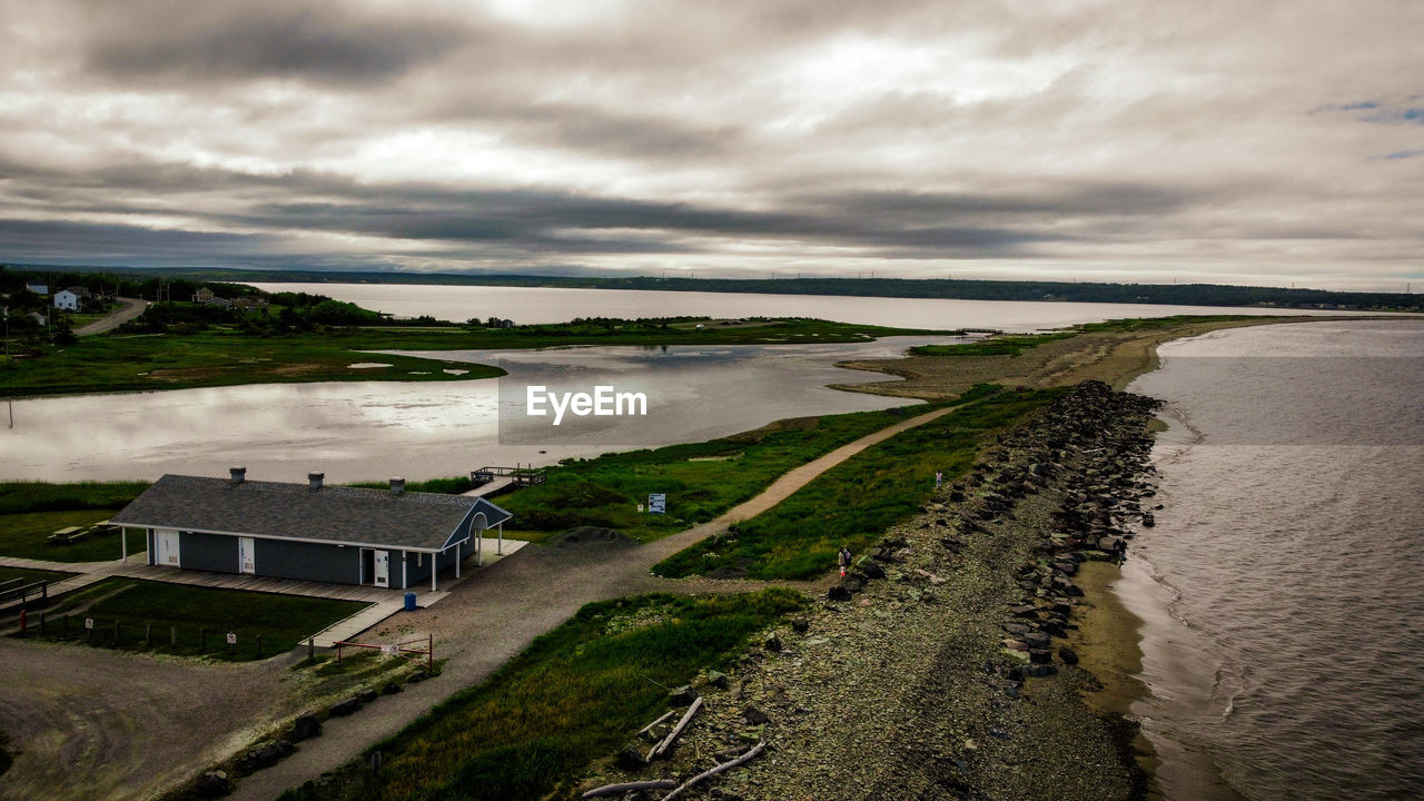 coast, water, cloud, sea, sky, shore, environment, land, nature, horizon, beach, reflection, ocean, landscape, architecture, scenics - nature, beauty in nature, built structure, morning, coastline, no people, travel destinations, body of water, travel, building, outdoors, bay, plant, aerial photography, dramatic sky, tourism, building exterior, tranquility, rural area, grass, cloudscape, sunlight, environmental conservation, overcast, non-urban scene, reservoir, rural scene, dusk, house, wave