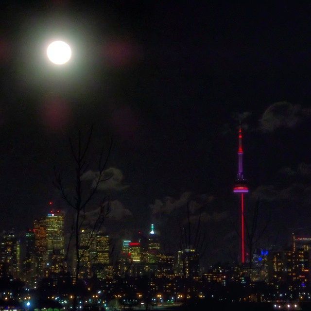 VIEW OF ILLUMINATED CITYSCAPE AT NIGHT