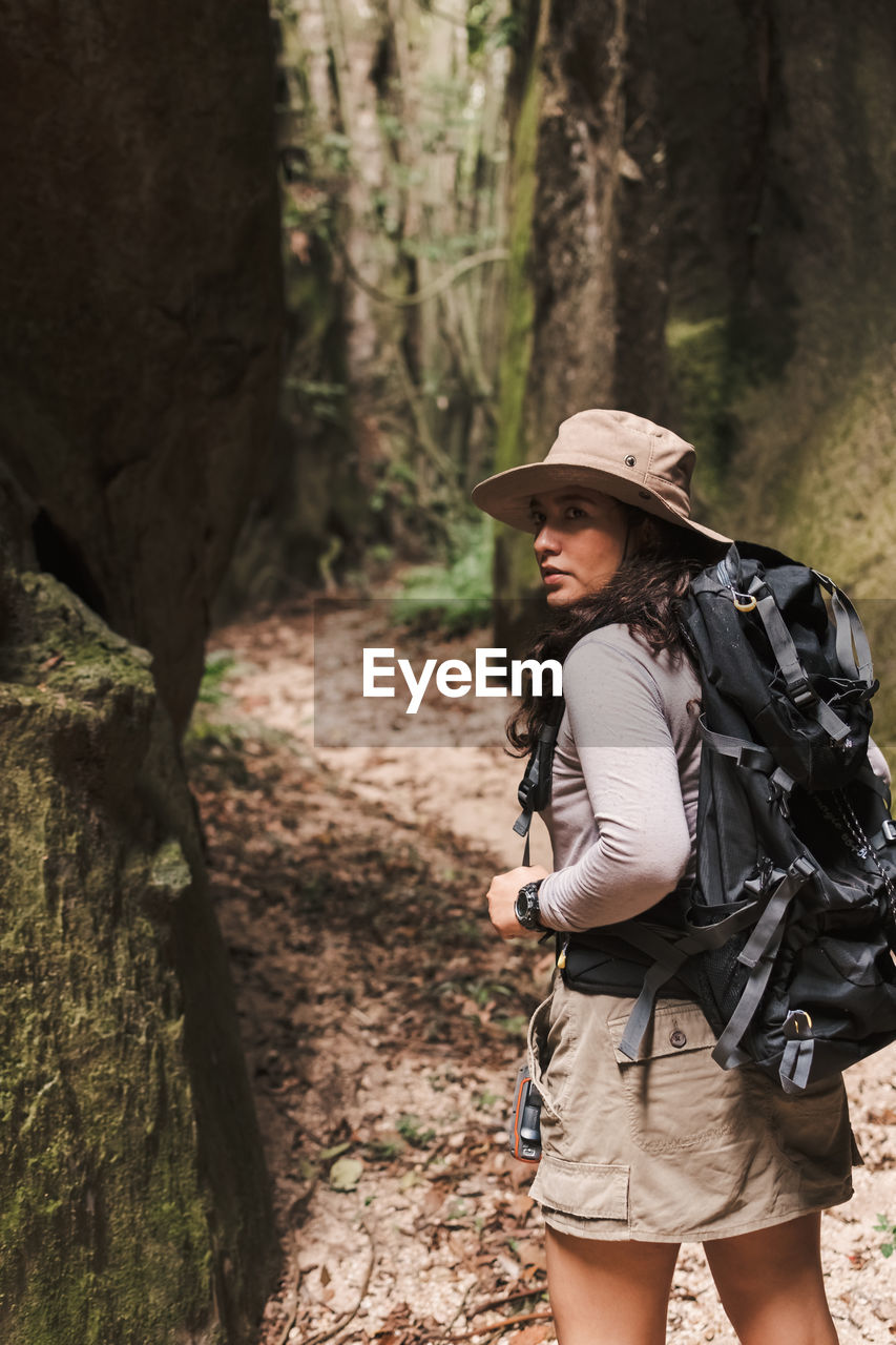 Young woman looking back in a canyon