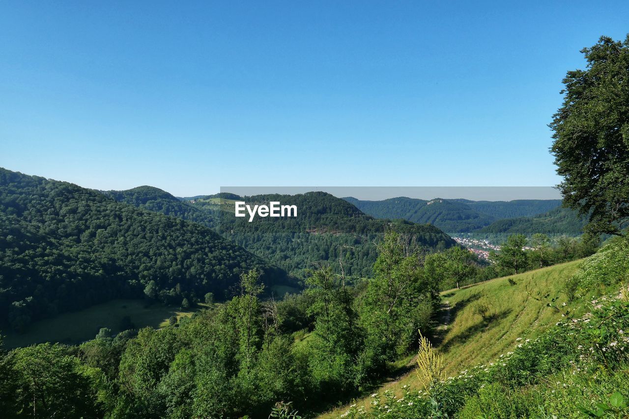 Scenic view of mountains against clear blue sky