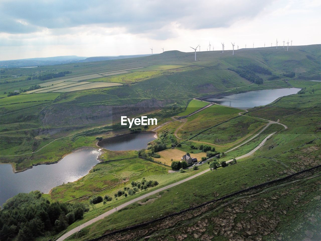 HIGH ANGLE VIEW OF LAND AND PLANTS ON LANDSCAPE AGAINST SKY