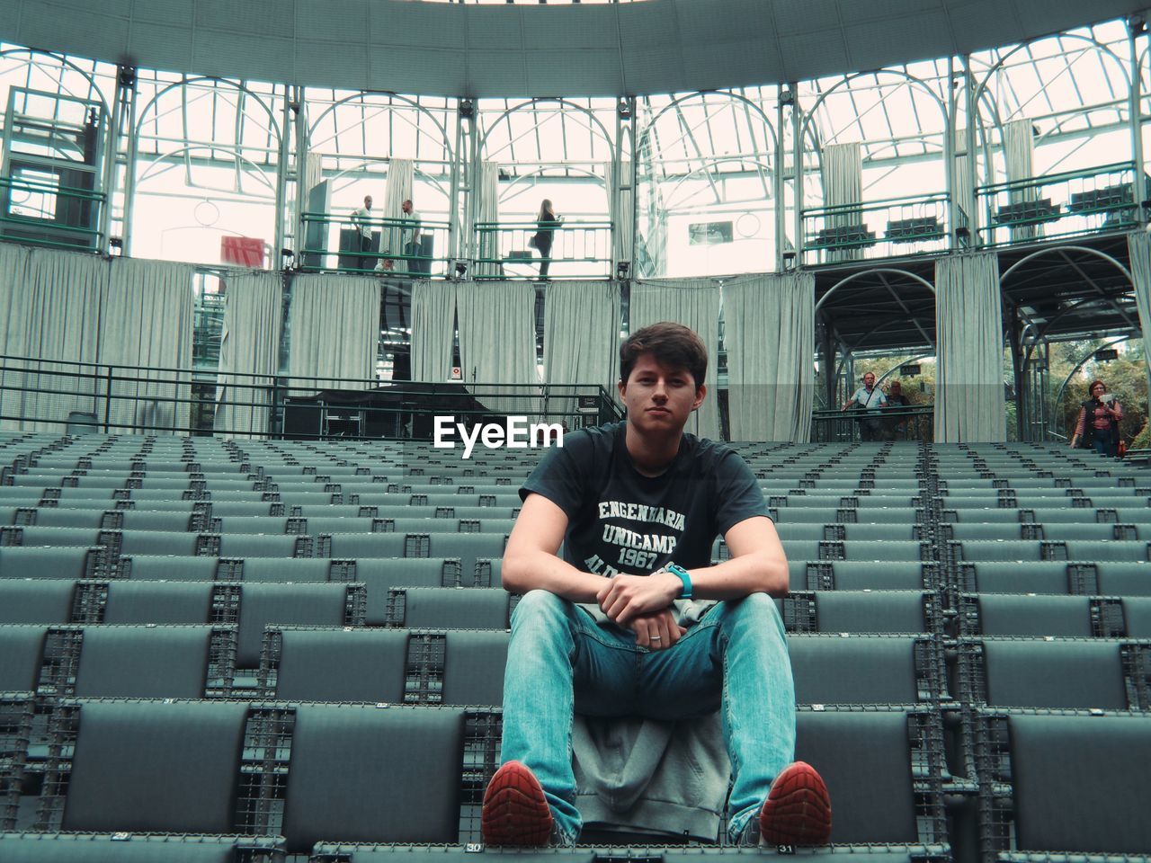 Portrait of young man sitting on seat