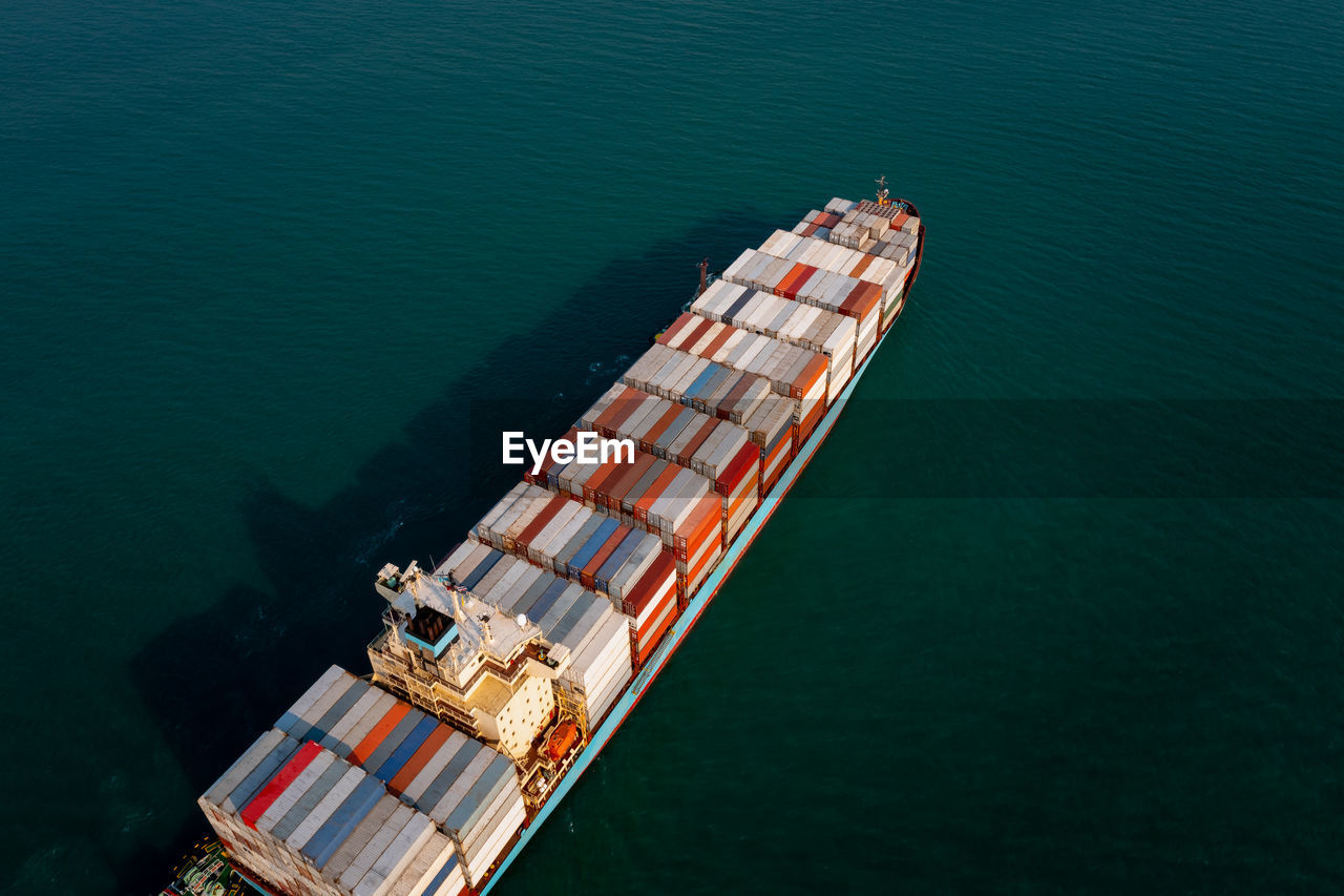 Aerial view container cargo ship large floating carrying commercial container in import export