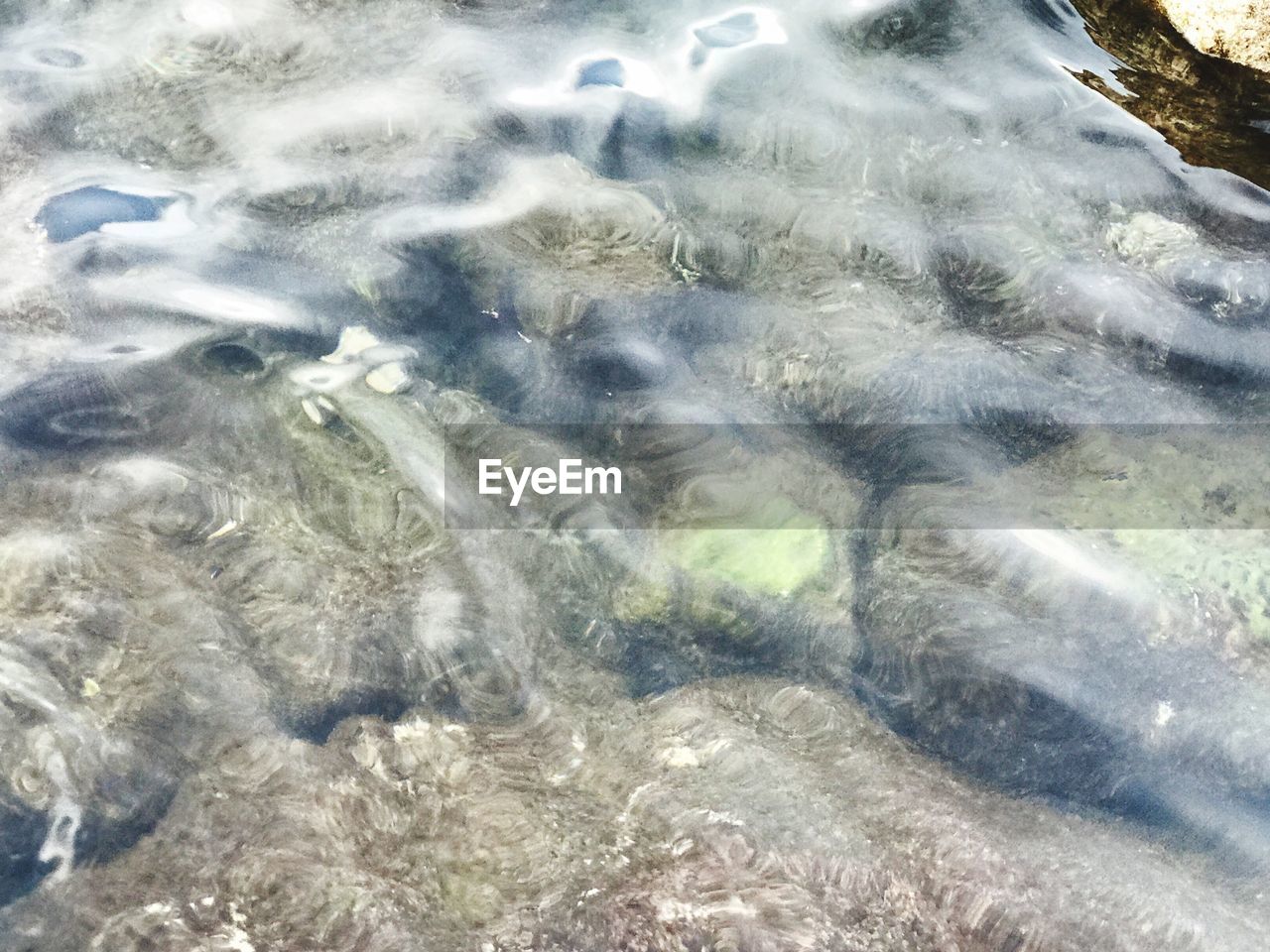 FULL FRAME SHOT OF WATER FLOWING IN SHALLOW