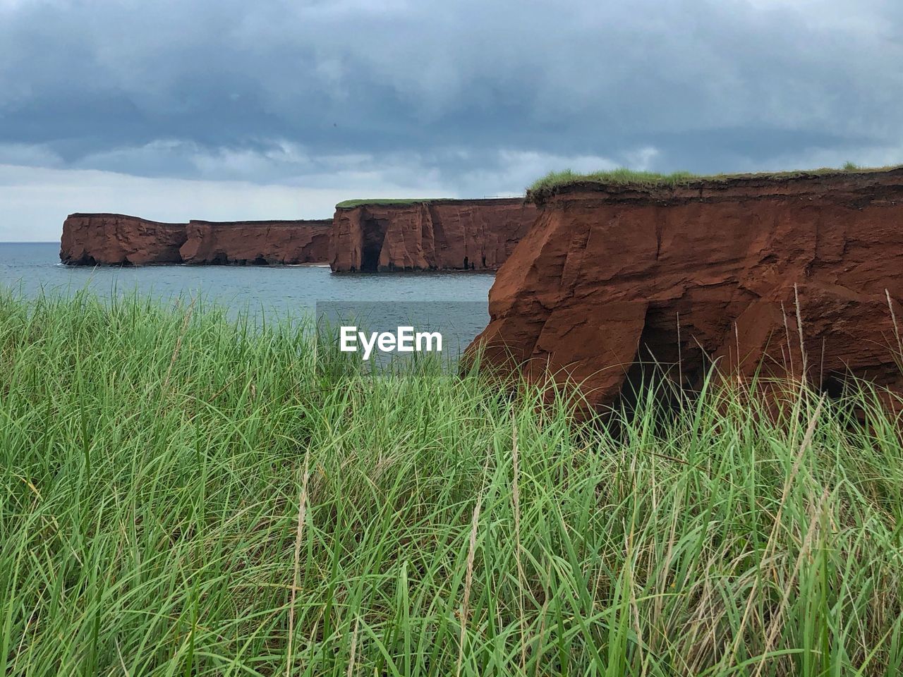 SCENIC VIEW OF ROCKS ON SHORE AGAINST SKY