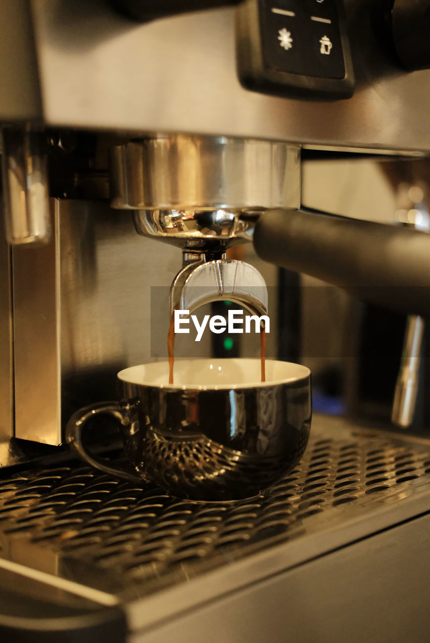 close-up of coffee pouring in cafe