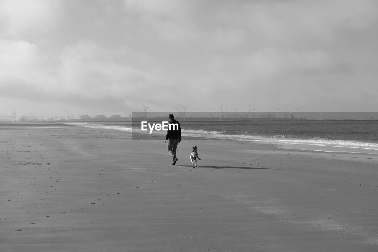 MAN IN SEA AGAINST SKY