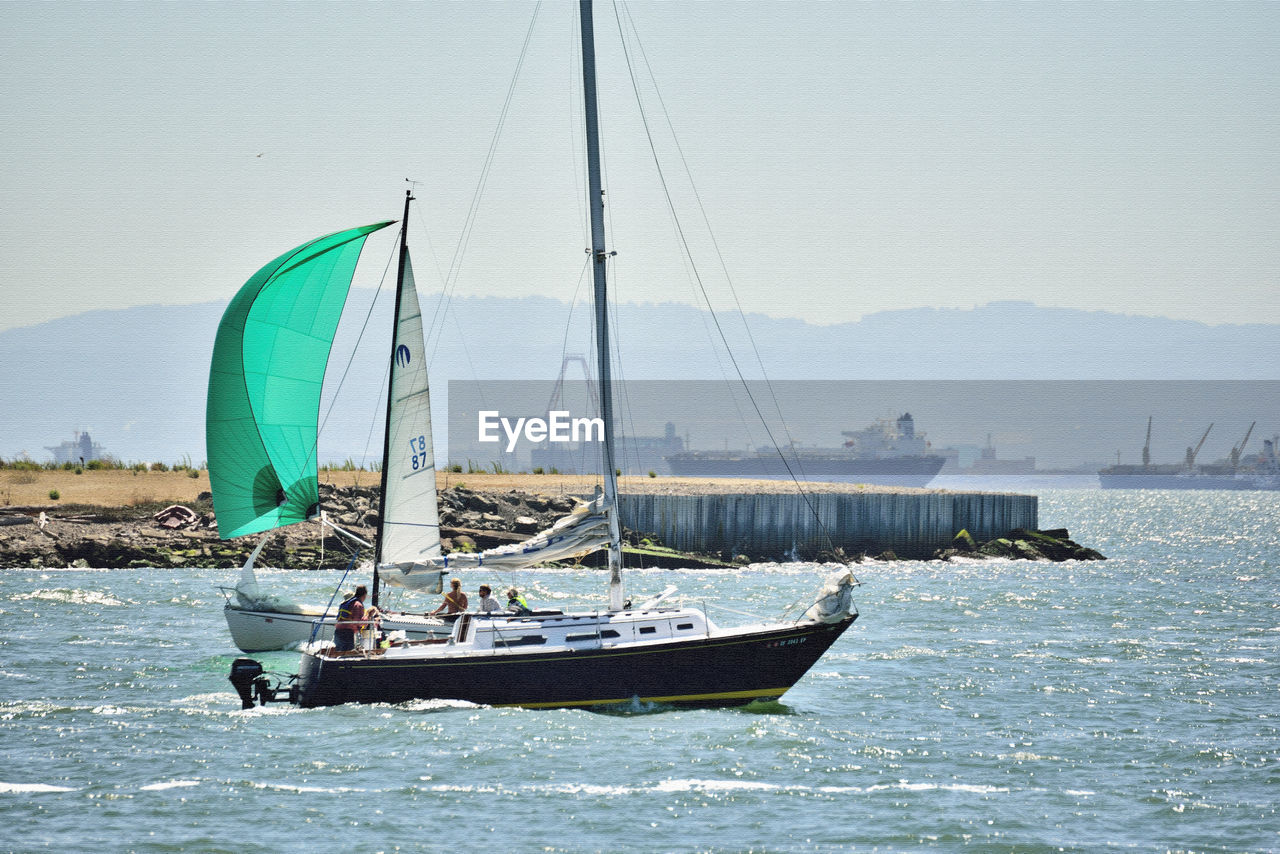 BOATS SAILING IN SEA