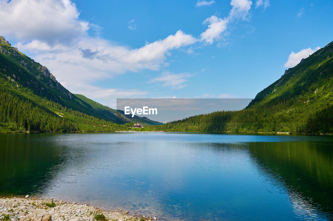 Scenic view of lake and mountains against sky