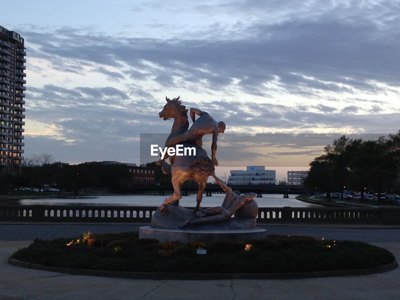 STATUE OF DOG AGAINST SKY DURING SUNSET