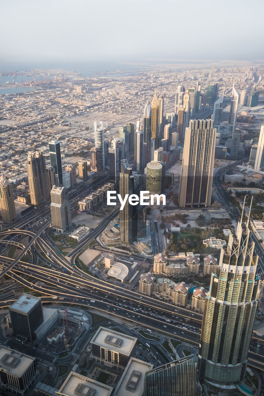 HIGH ANGLE VIEW OF MODERN BUILDINGS AGAINST SKY IN CITY