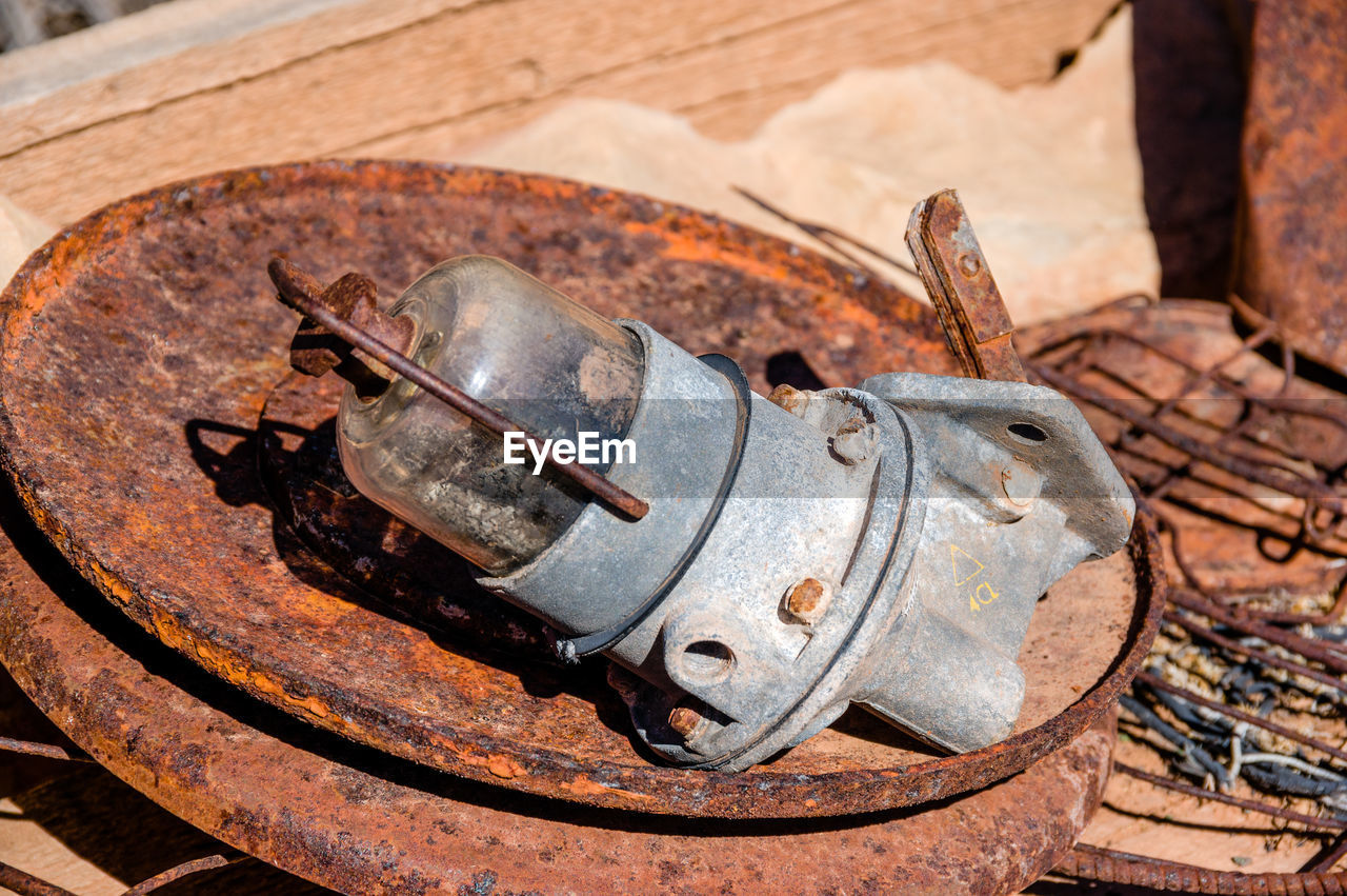 HIGH ANGLE VIEW OF OLD RUSTY MACHINE PART