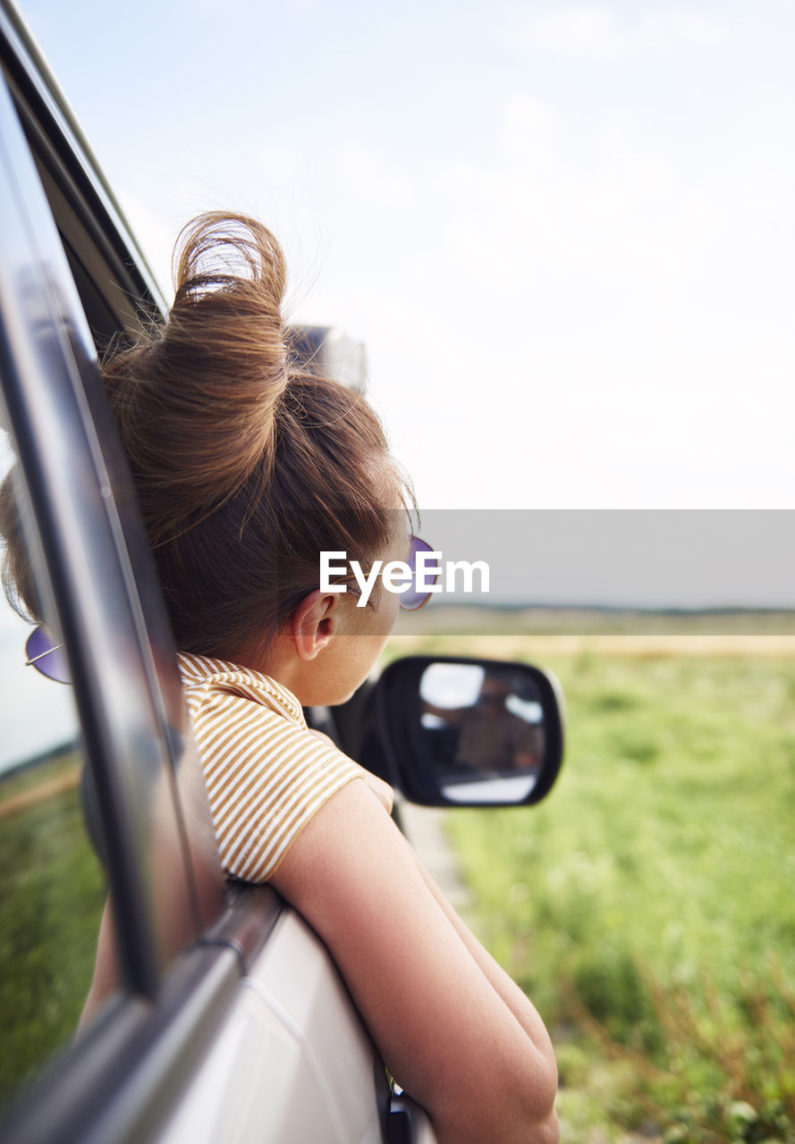 Woman peeking from car window