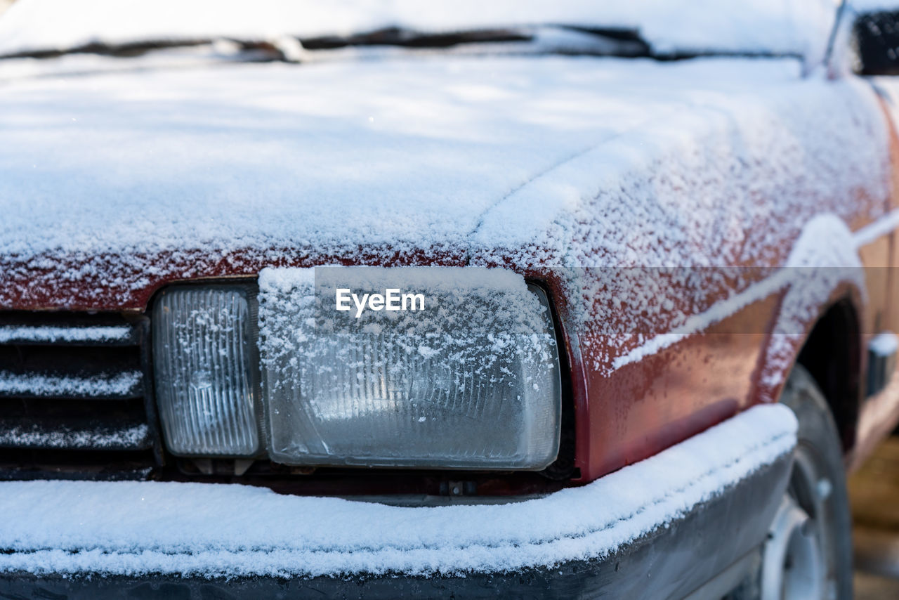 CLOSE-UP OF ICICLES IN SNOW COVERED CAR