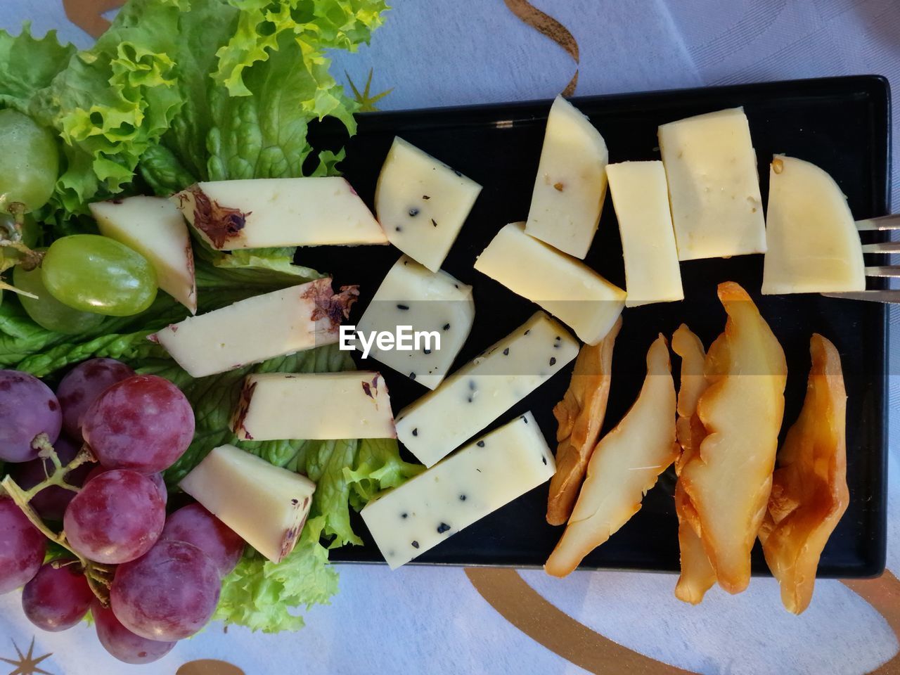 food and drink, food, cheese, freshness, vegetable, healthy eating, dish, no people, indoors, wellbeing, high angle view, produce, still life, meal, dairy, directly above, cuisine, fruit, plate, table, cutting board, salad, lunch, appetizer, raw potato, herb, close-up, fast food