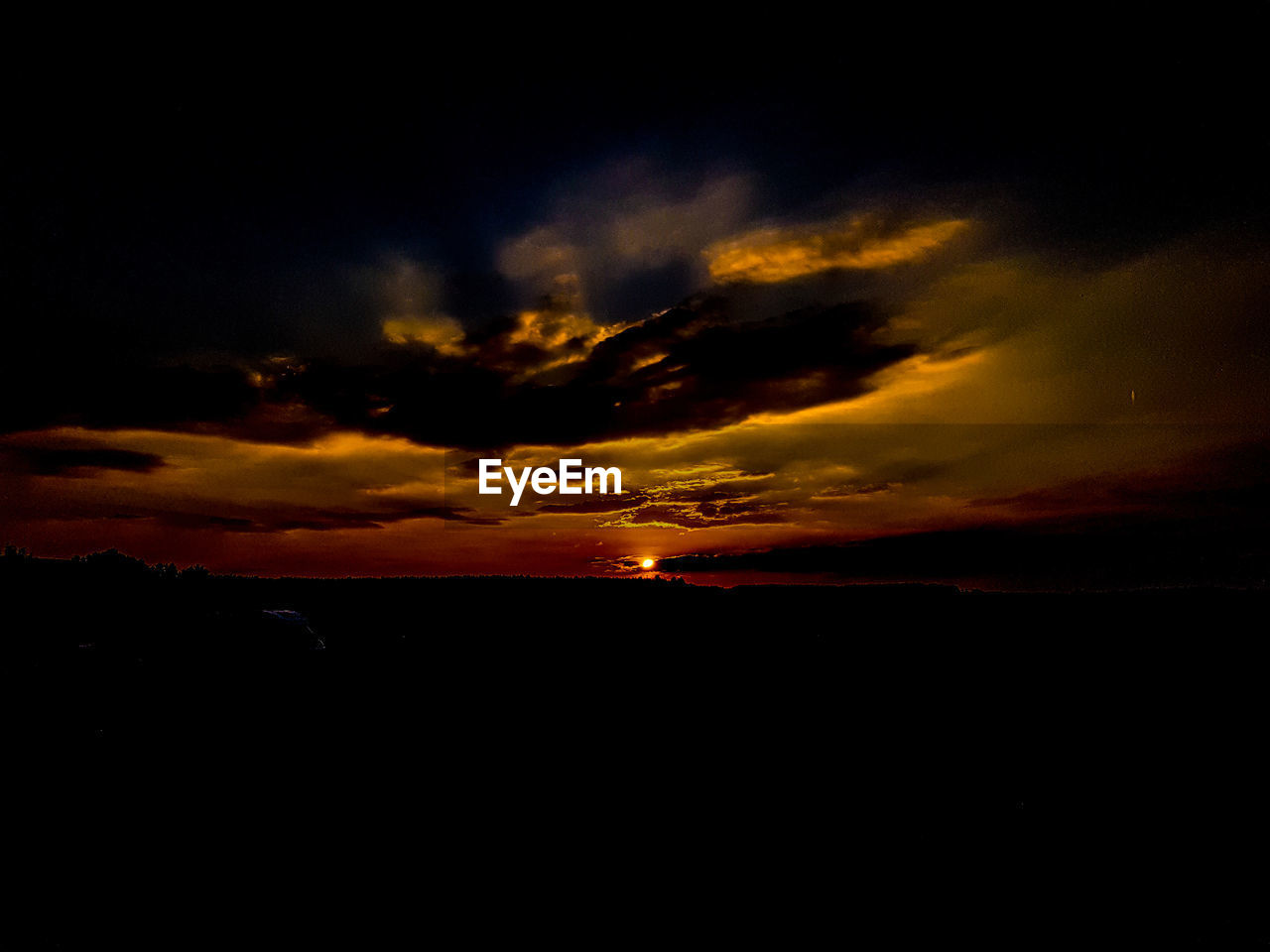 SILHOUETTE LANDSCAPE AGAINST CLOUDY SKY