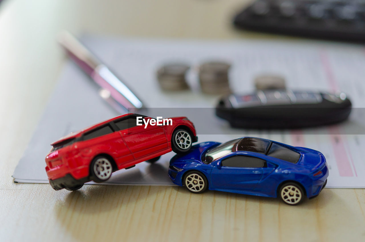 CLOSE-UP OF VINTAGE TOY CAR ON TABLE