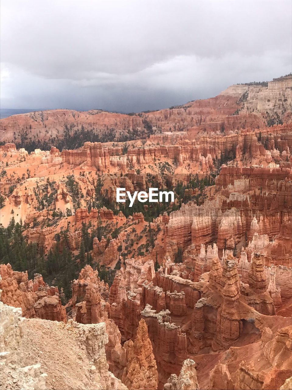 VIEW OF ROCK FORMATIONS AGAINST CLOUDY SKY