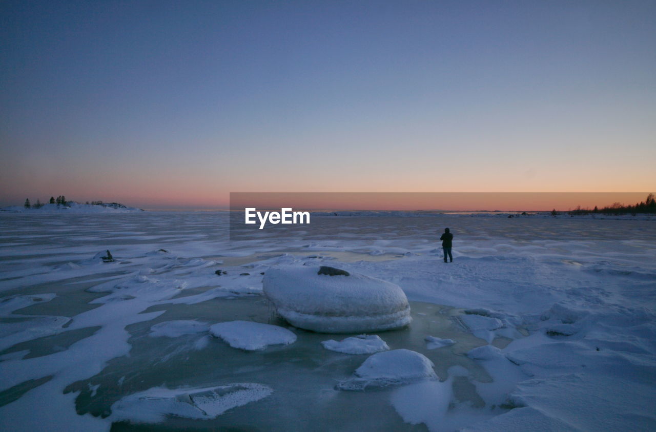 Scenic view of sea against clear sky during sunset