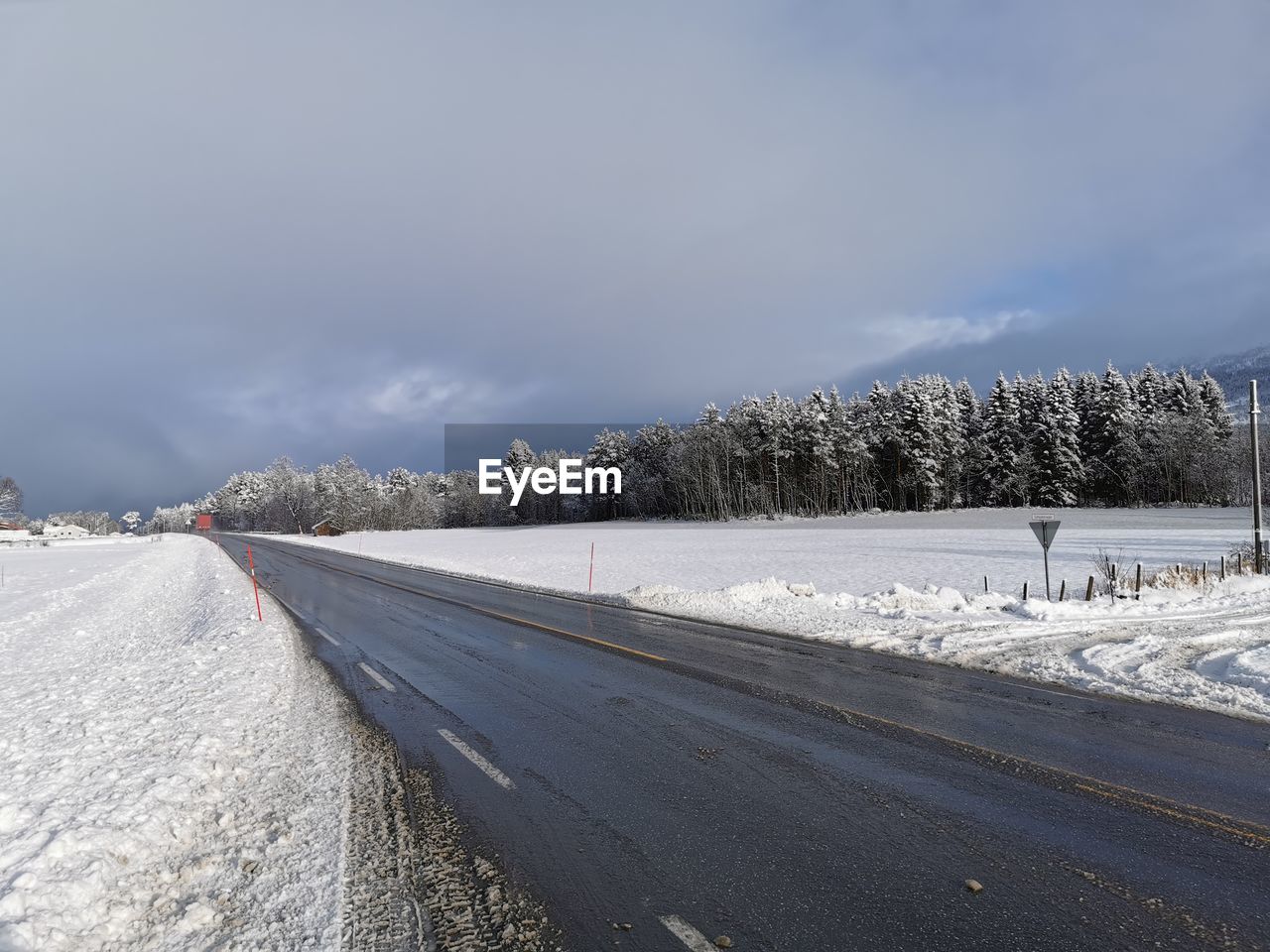 Snow covered road against sky