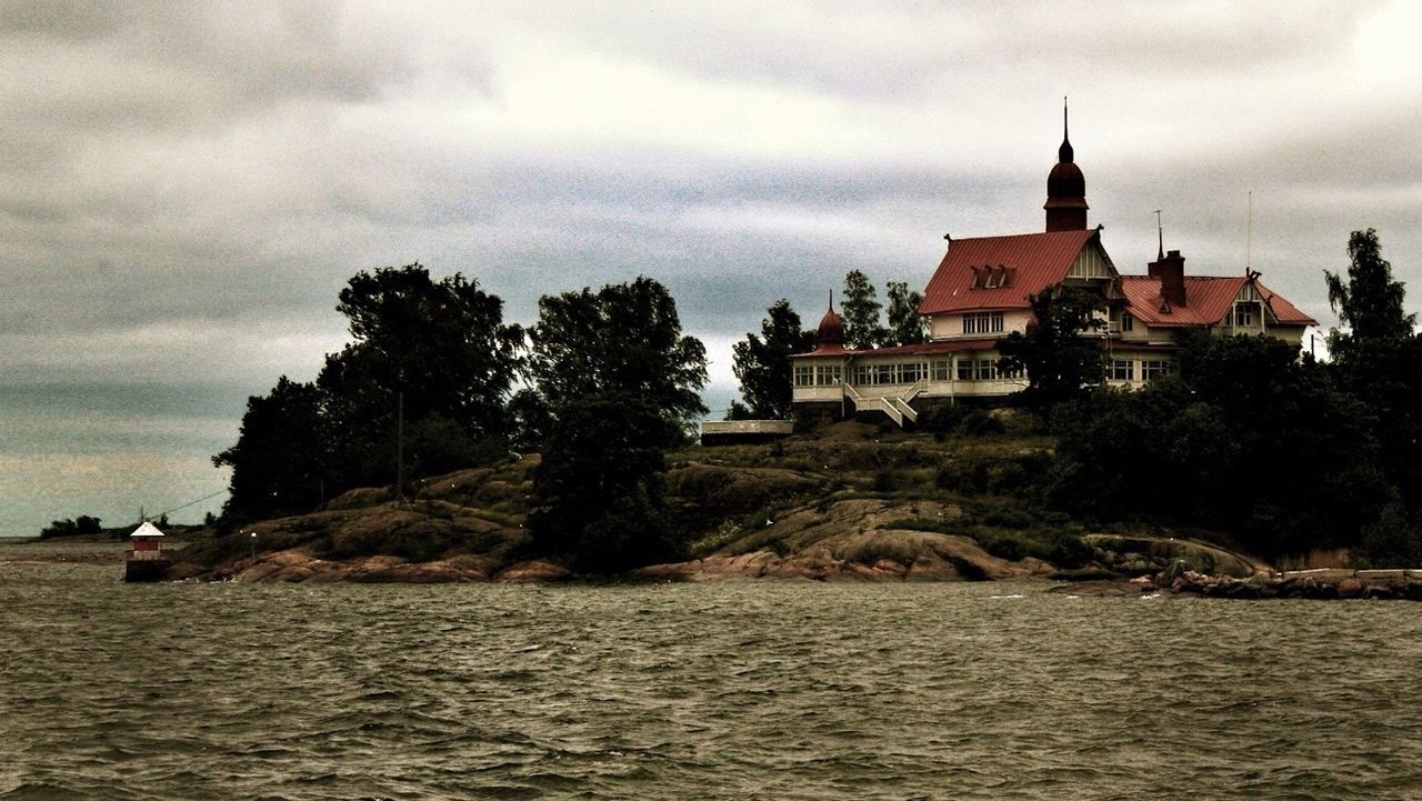 Houses against cloudy sky