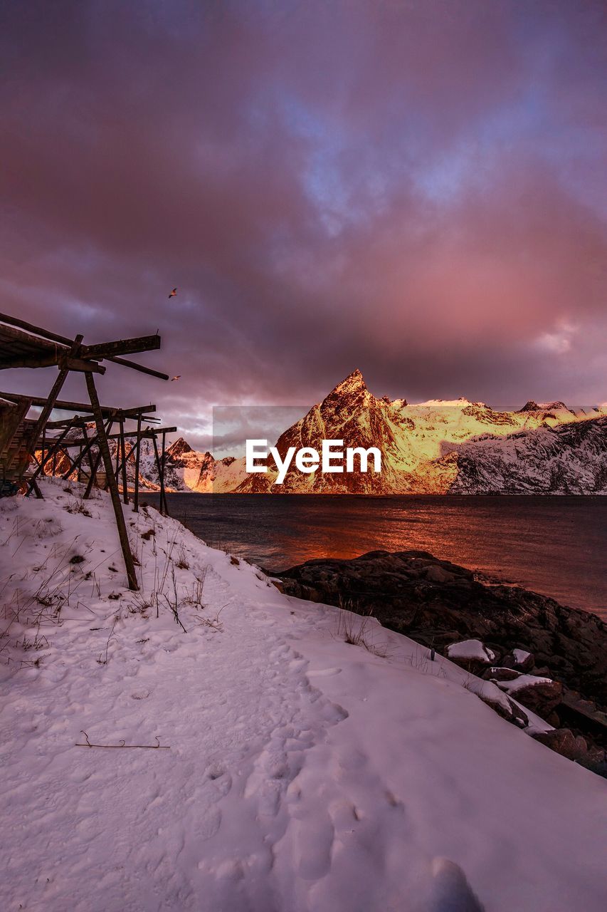 River and mountains against sky during winter