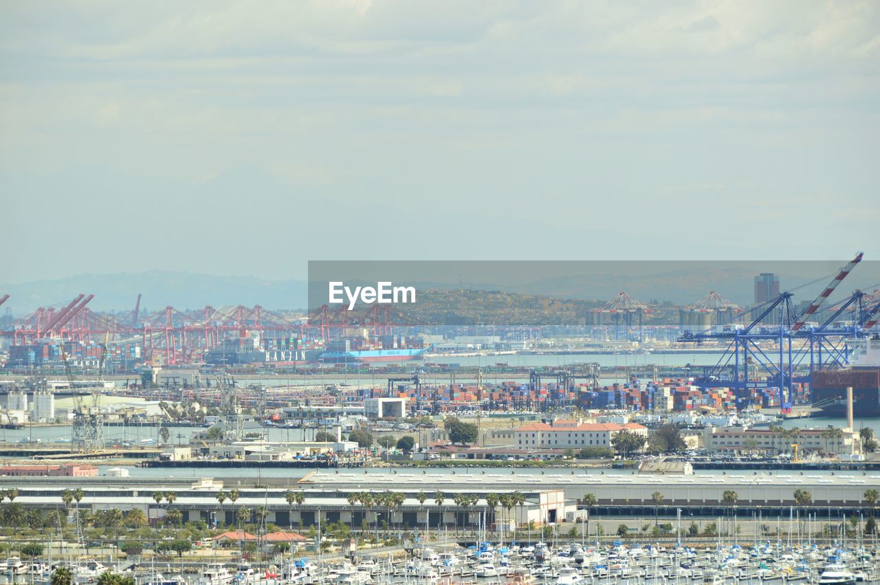 Harbor against sky in city