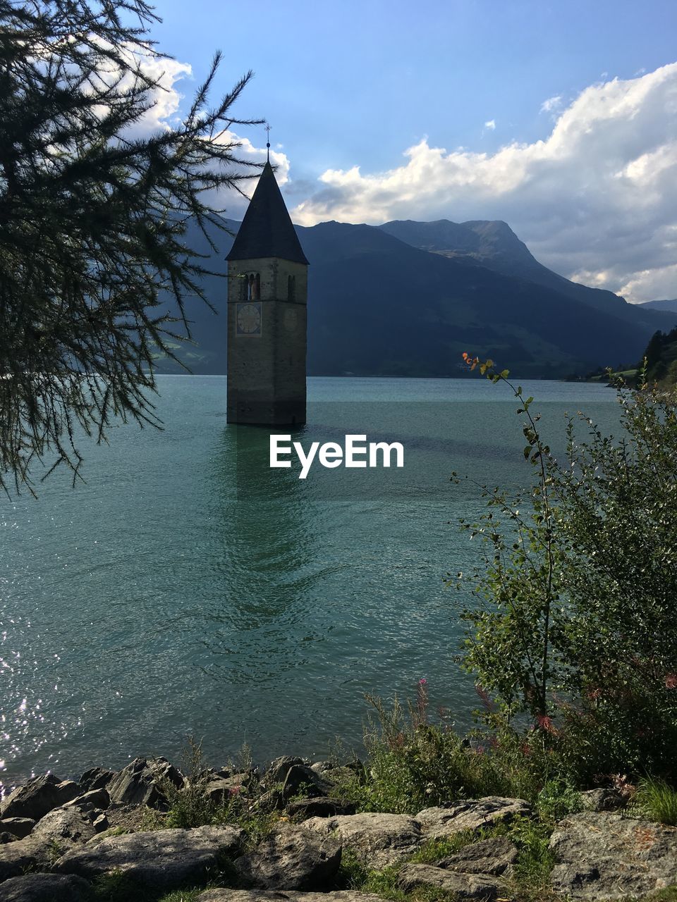Sunken village, tower of a church in the lake