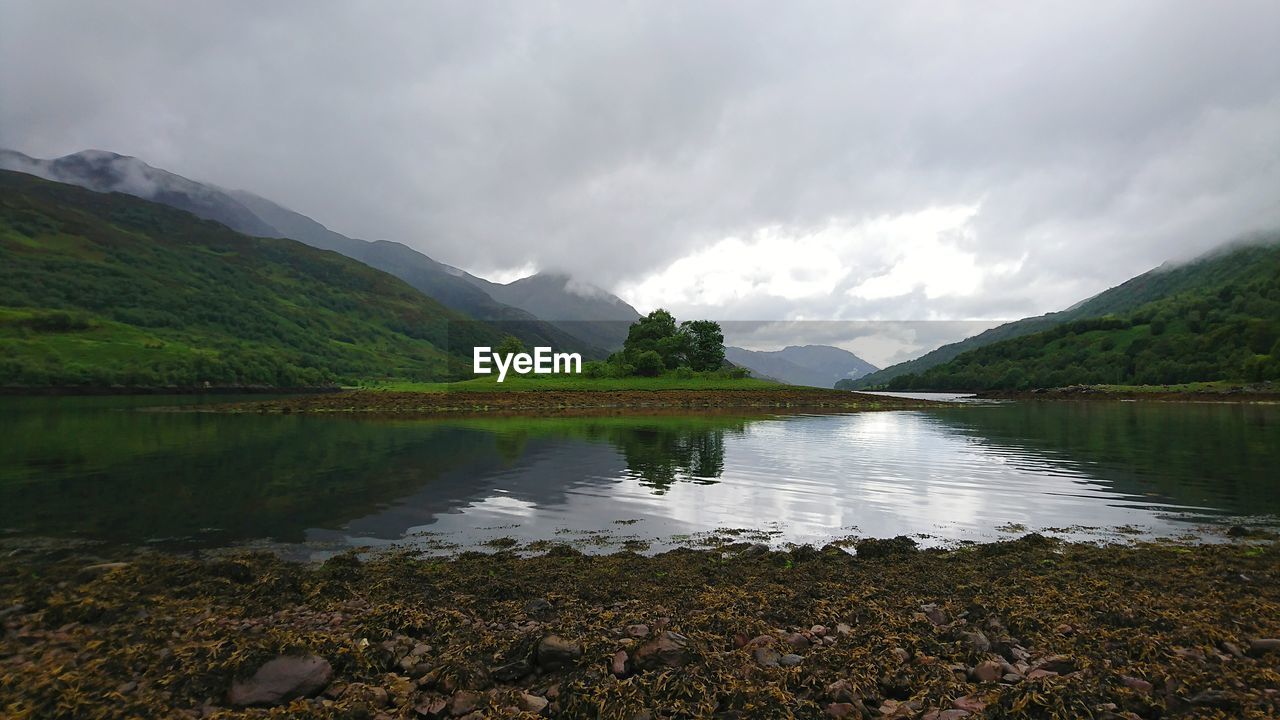 Scenic view of lake and mountains against sky