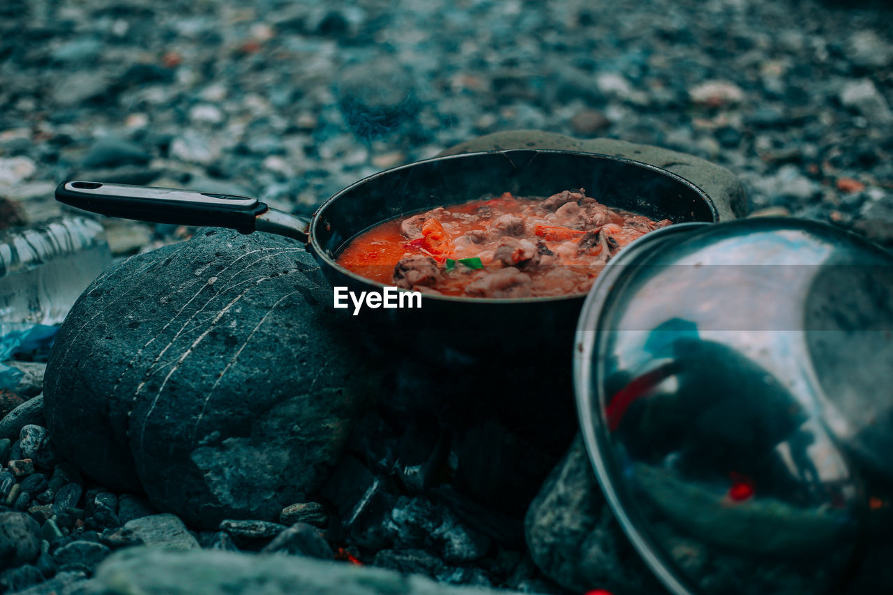 Close-up of food cooking in pan on camping stove