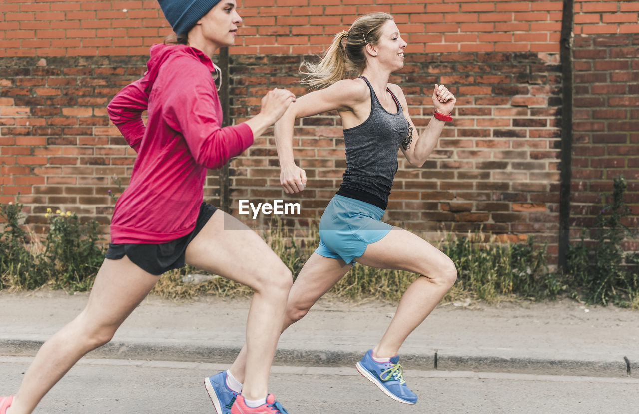 Two women running on the street