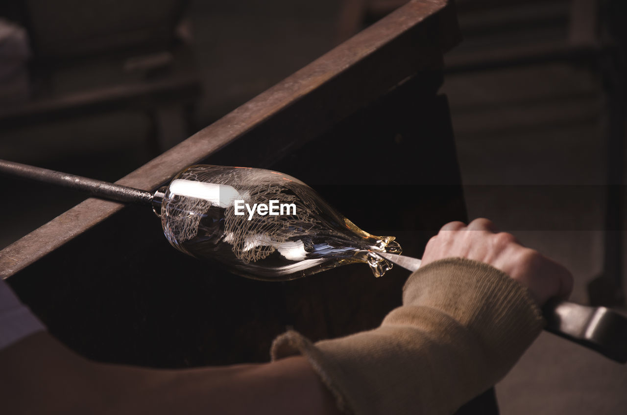 Close-up of person making glassware