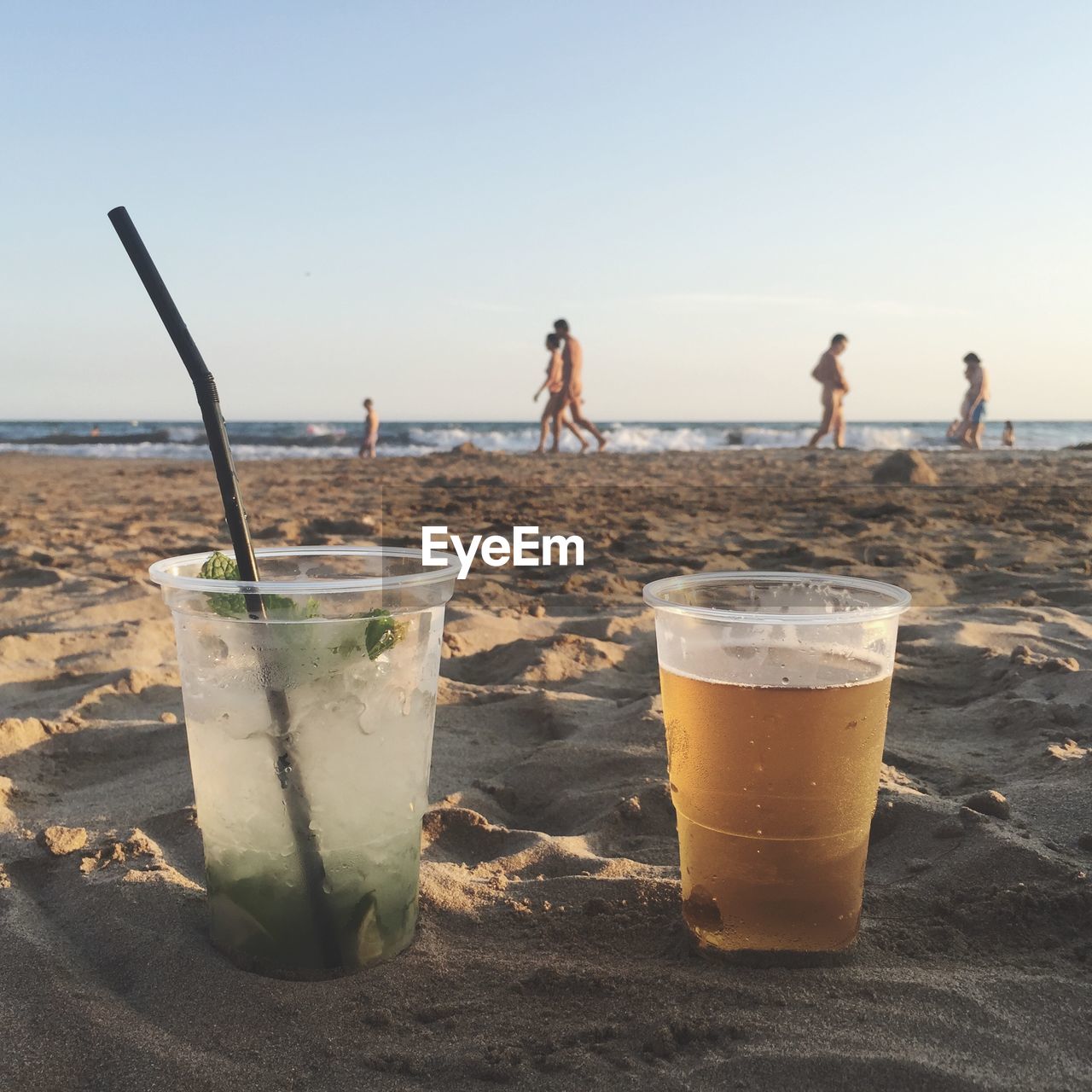 Close-up of drinks on beach