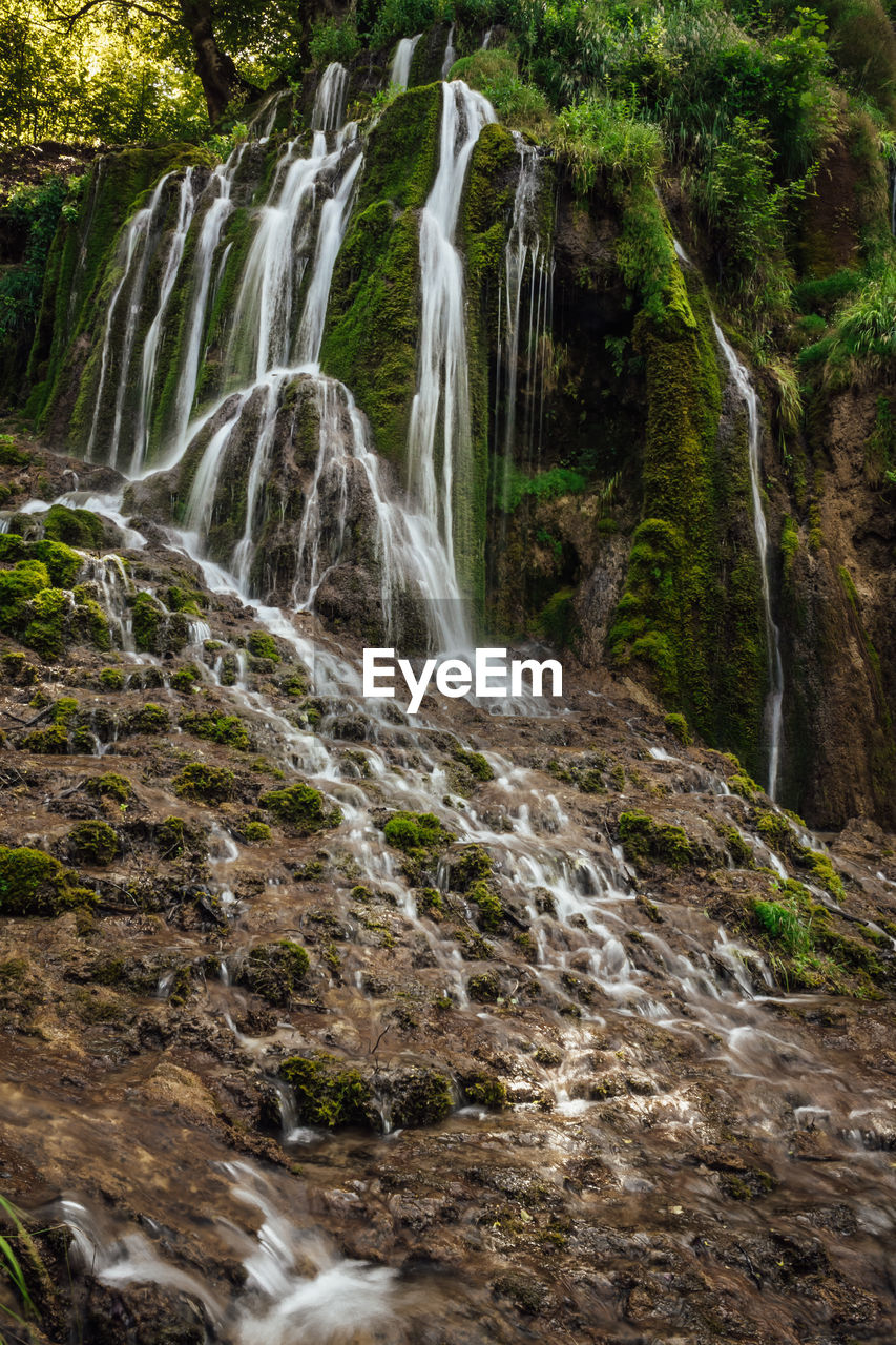 Small mountain waterfall deep in the woods, preserve clean water