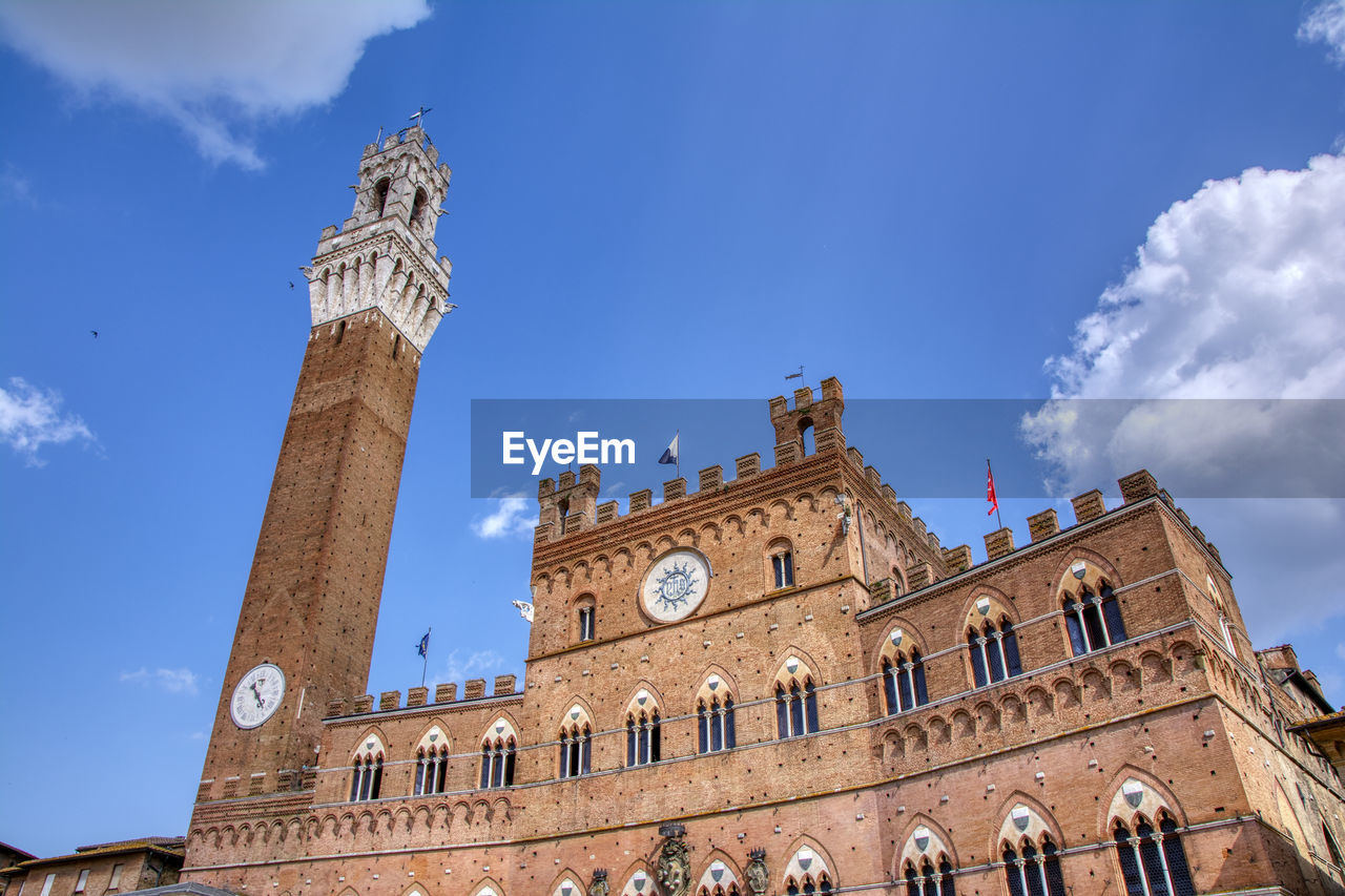 The piazza del campo with the mangia tower in siena town in the tuscany region of italy, europe.