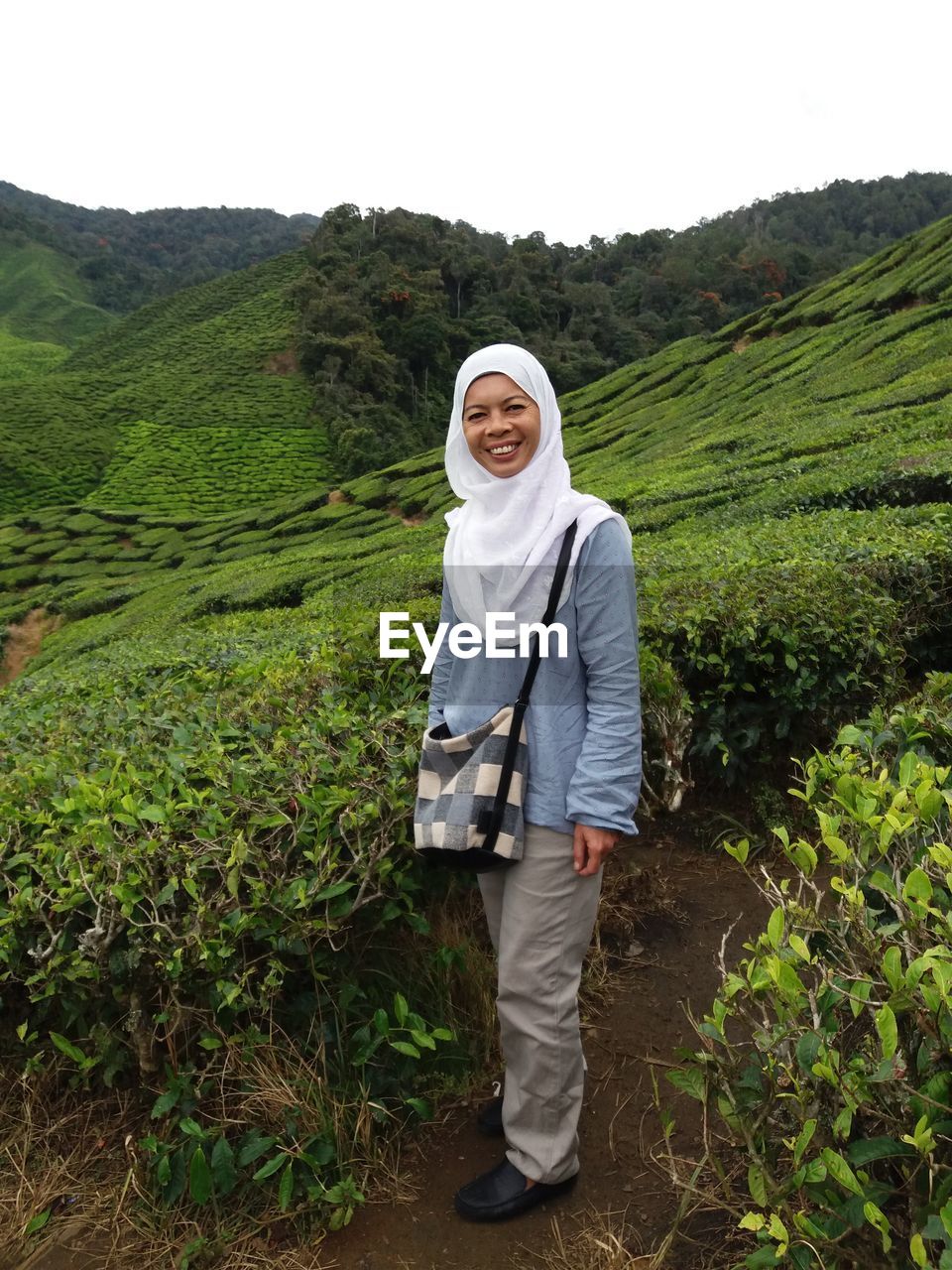 Portrait of woman standing at tea plantation